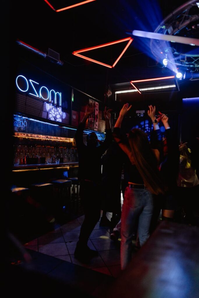 The Art of Drawing Readers In: Your attractive post title goes here Vibrant nightclub with people dancing under neon lights, perfect for nightlife themes.
